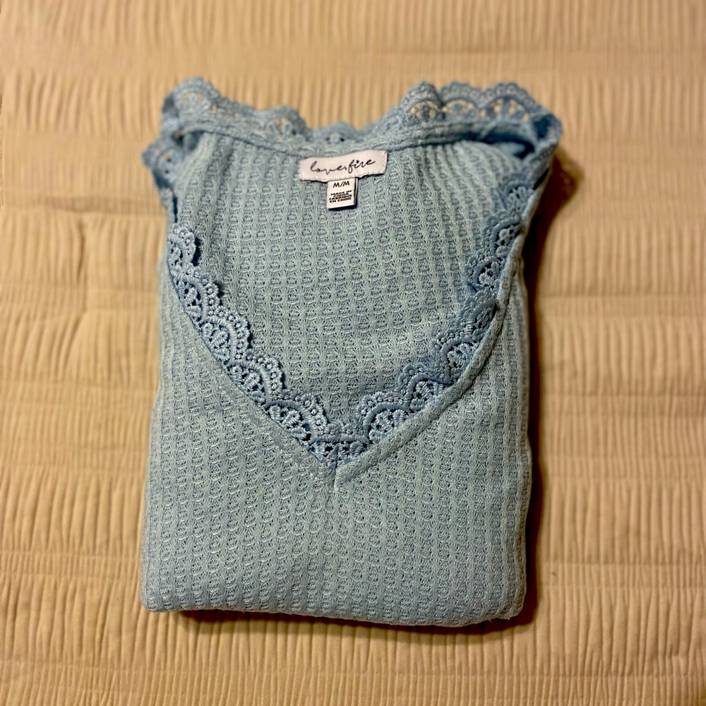 Medium light blue long sleeve knit, waist length coverage. Breathable sleeve.